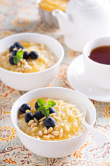 Cooked millet porridge with lemon curd and blueberry