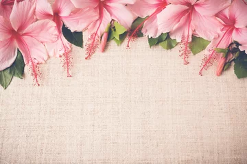 Foto op Canvas Pink Hibiscus flowers on linen, International Women's Day background © SewcreamStudio