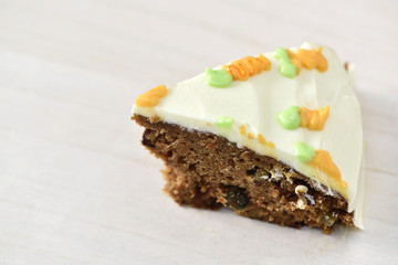 Slice carrot cheese cake on wood plate in christmas background