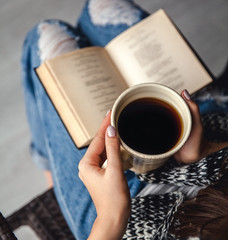 girl having a break with cup of fresh coffee after reading books or studying