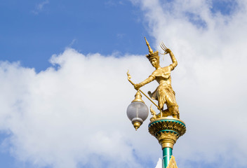 Fototapeta na wymiar Golden statue of native thai art with street lamps