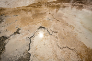 Dark amber geothermal pools over travertine rock, Yellowstone National Park, Wyoming.