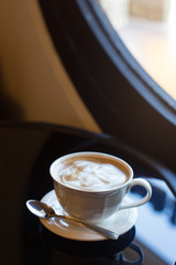 Hot art Latte Coffee in a cup and laptop on table