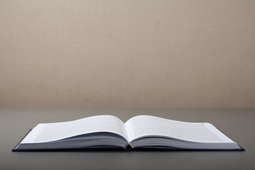 Open book on a gray table closeup