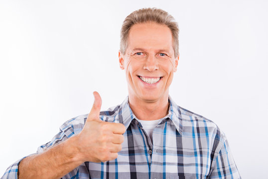 Handsome mature man showing gesture thumb up