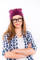 beautiful confident girl in a hipster hat and shirt crossed her
