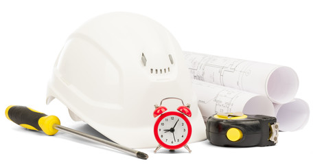Alarm clock and helmet on white 