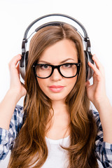 cute girl with glasses  enjoying  music on headphones