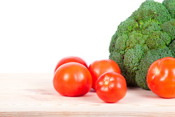 broccoli and tomatoes isolated on wood