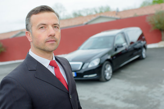 funeral director with car