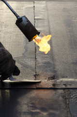 flame during welding of a waterproofing membrane on a roof