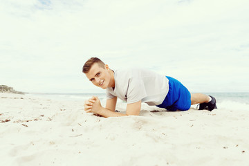 Man training on beach outside