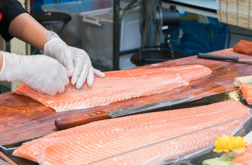 chef slicing salmon
