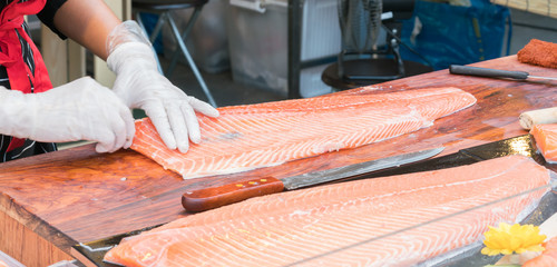 chef slicing salmon

