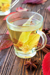 Cup of linden tea on wooden background