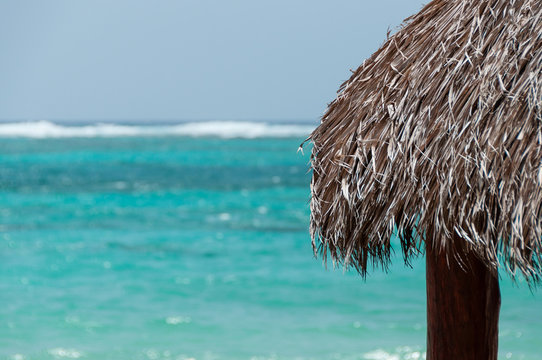 The Native Roof made of leave facing the blue caribbean ocean on Little Corn Island