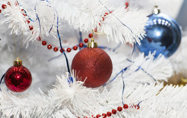 Fototapeta na wymiar Christmas tree decorated with toys. White Christmas tree decorated with balls. 