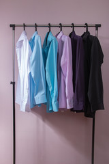 Obraz premium colored men's shirts that hang on hangers