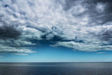 Naklejka na ściany i meble Clouds over Baltic sea.