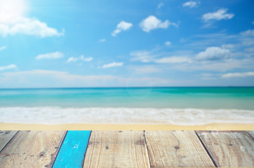 Blur tropical beach with sun light on old empty wood table background.