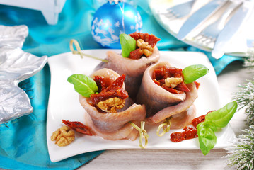 appetizer of herring rolls with dried tomato and walnuts for chr