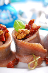 appetizer of herring rolls with dried tomato and walnuts for chr