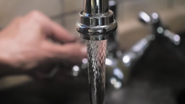 Turning On Water To The Kitchen Sink Close Up