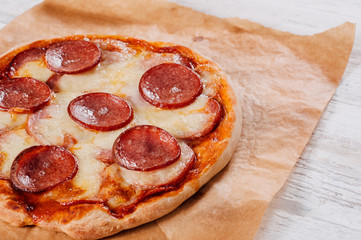 Baked homemade pizza on baking paper