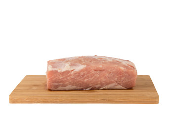 Raw piece of meat on a wooden board on a white background