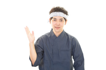 案内する笑顔の寿司職人