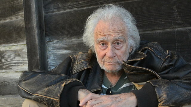 Homeless senior man in a alley