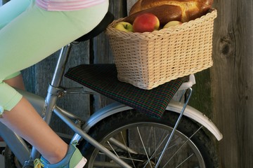 basket by bicycle with apples and pastries
