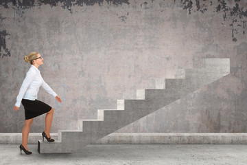 Obraz na płótnie Canvas Business woman walking up a staircase. 