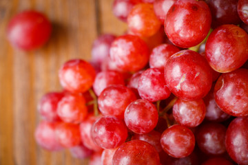 Red grape on wooden table, Healthy concept.