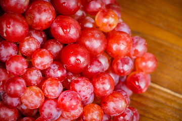 Red grape on wooden table, Healthy concept.