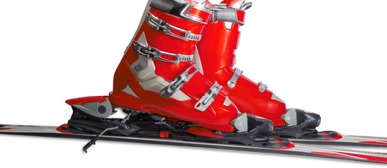 Alpine ski boots in ski binding closeup
