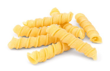 Several spirals of uncooked Torchietti pasta closeup isolated on white background.