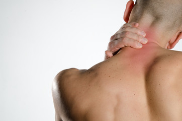 a young man holding neck in pain