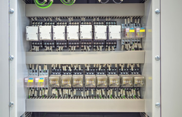 Electrical control panel with relays and wires closeup