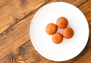 Banana muffin cake on white plate put on wooden table.