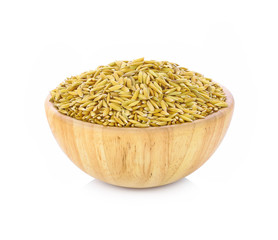 paddy grains in wooden bowl isolated on white background.
