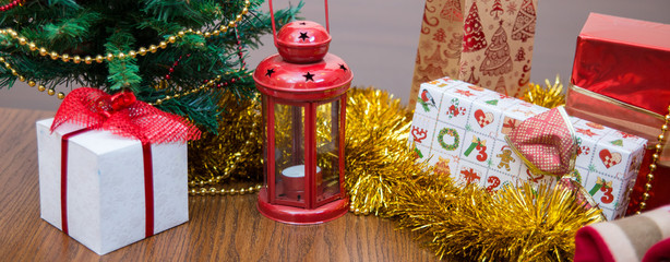 Christmas celebration things: firtree with gifts under it, decor