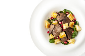 Salad with chicken liver and spinach in the white background top view