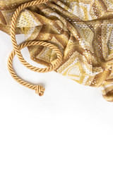 gold rope and silkon a white background