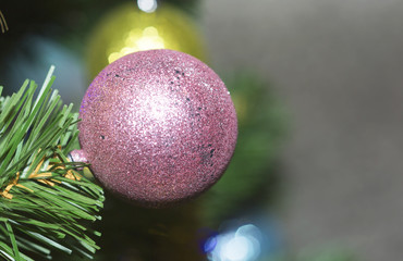 Christmas tree decorated with toys. Ball hanging on a branch of a tree. 