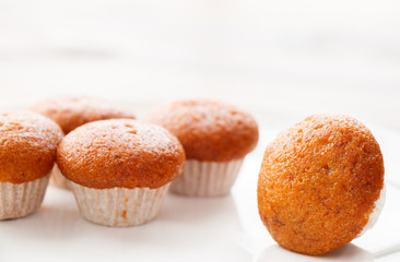 Banana muffin cake on white plate put on wooden table.