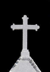 White cross in  cemetery on black background.