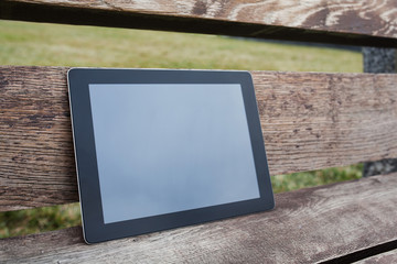 tablet pc computer gadget with isolated screen on a wooden backg