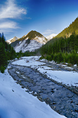 The mountain river in winter sunny day. Beautiful winter landsca