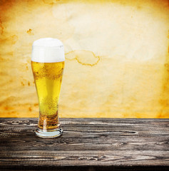 glass of fresh lager beer on a wooden table
